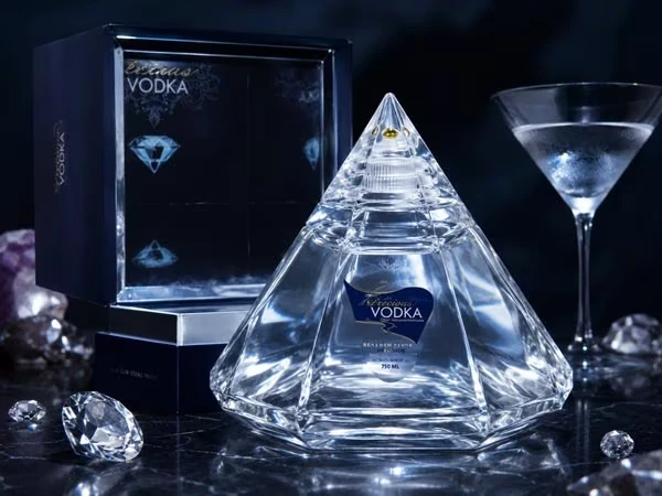 Precious Vodka Jewel Lines in diamantförmiger Glasflasche neben Geschenkbox und Vodka-Martini